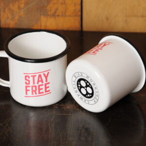 Stay Free enamel mugs showing the Campbell Bike Workshop logo on the base